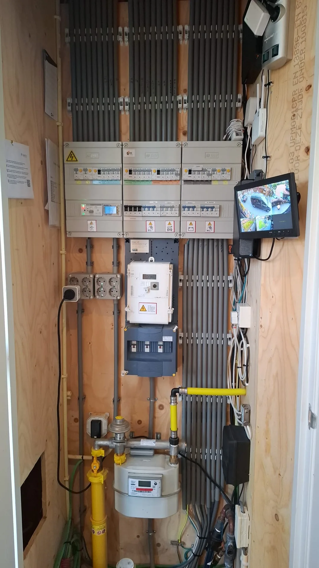 Vernieuwde meterkast met meerdere groepenkasten, een slimme meter en netjes gebundelde kabels